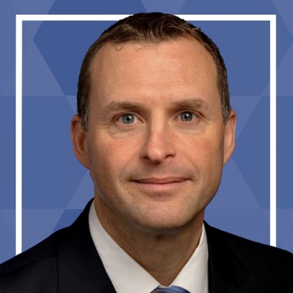 Professional male in a suit with a blue fainted hexagonal background